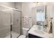 Modern bathroom featuring a glass-enclosed shower, toilet, and vanity with sleek fixtures, providing a spa-like experience at 6123 Chester Way, Denver, CO 80238