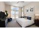 Spacious bedroom featuring large windows, stylish furnishings, and a comfortable bed, creating a relaxing retreat at 6123 Chester Way, Denver, CO 80238