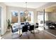 Bright and airy dining area with ample windows, modern light fixture, and sliding glass doors to an outdoor space at 6123 Chester Way, Denver, CO 80238