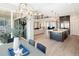 Open-concept living space featuring a dining area that overlooks a kitchen with an island, and a fireplace in the living room at 6123 Chester Way, Denver, CO 80238