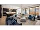 Cozy living room with large sectional, marble coffee table, and sleek, modern kitchen at 6123 Chester Way, Denver, CO 80238