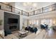 Open-concept living room with soaring ceilings, fireplace and spacious seating, with a view of the second story at 6123 Chester Way, Denver, CO 80238