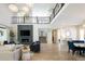Open concept home featuring a modern fireplace, staircase and hardwood floors at 6123 Chester Way, Denver, CO 80238