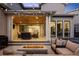 Beautiful outdoor patio with a fire pit, comfortable seating, and elegant string lights at 6123 Chester Way, Denver, CO 80238