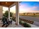 Relaxing covered porch with Adirondack chairs and a view of the beautiful landscape at 6123 Chester Way, Denver, CO 80238