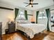Comfortable bedroom featuring hardwood floors, a well-dressed bed, and ample natural light at 6346 Fenton St, Arvada, CO 80003