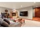 Finished basement with stone fireplace, large TV, and comfortable seating area at 168 Corkscrew Dr, Breckenridge, CO 80424