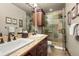 Well-lit bathroom featuring double sinks, granite countertops, and a stone shower at 168 Corkscrew Dr, Breckenridge, CO 80424