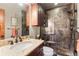 Modern bathroom with walk-in shower, granite countertops, and dark wood cabinets at 168 Corkscrew Dr, Breckenridge, CO 80424