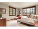 Well-lit bedroom featuring an accent chair by a pair of windows offering mountain views at 168 Corkscrew Dr, Breckenridge, CO 80424