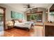Bright bedroom boasts a large window offering wooded views, vaulted ceiling, and hardwood floors at 168 Corkscrew Dr, Breckenridge, CO 80424