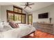 Light filled bedroom with many windows that look out into a wooded view and a door to the outside at 168 Corkscrew Dr, Breckenridge, CO 80424