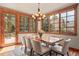 Elegant dining room featuring a unique wood table and abundant natural light at 168 Corkscrew Dr, Breckenridge, CO 80424
