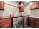 Well-organized laundry room featuring front load washer and dryer with countertop and abundant cabinet space at 168 Corkscrew Dr, Breckenridge, CO 80424