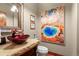 Unique powder room with stone countertop and artistic mirror at 168 Corkscrew Dr, Breckenridge, CO 80424