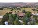 Aerial view of house, expansive backyard, and mountain backdrop at 12768 Grizzly Dr, Littleton, CO 80127