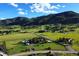 Aerial view of house and surrounding land with mountain views at 12768 Grizzly Dr, Littleton, CO 80127