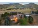 Elevated view of house, patio, and basketball court at dusk at 12768 Grizzly Dr, Littleton, CO 80127