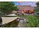 Backyard oasis with pond, patio, and shade sail at 12768 Grizzly Dr, Littleton, CO 80127