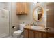 Clean bathroom with shower, toilet and wood vanity at 12768 Grizzly Dr, Littleton, CO 80127