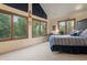 Bedroom with a queen-size bed and large windows with mountain views at 12768 Grizzly Dr, Littleton, CO 80127