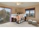 Bedroom with a twin-size bed, mountain views and sliding door access to balcony at 12768 Grizzly Dr, Littleton, CO 80127