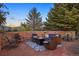 Stone patio with fire pit, seating area, and mountain views at 12768 Grizzly Dr, Littleton, CO 80127