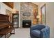 Cozy living room fireplace with stone surround and built-in shelving at 12768 Grizzly Dr, Littleton, CO 80127