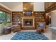 Elegant living room with a large stone fireplace and built-in bookshelves at 12768 Grizzly Dr, Littleton, CO 80127