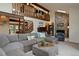 Spacious living room featuring a stone fireplace and lofted ceiling at 12768 Grizzly Dr, Littleton, CO 80127