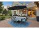 Inviting flagstone patio with outdoor dining set and string lights at 12768 Grizzly Dr, Littleton, CO 80127