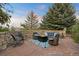 Relaxing stone patio with seating area, fire pit, and mountain views at 12768 Grizzly Dr, Littleton, CO 80127