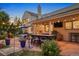 Stone patio features an outdoor kitchen and dining area at 12768 Grizzly Dr, Littleton, CO 80127