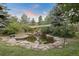 Serene pond with waterfall feature, surrounded by landscaping at 12768 Grizzly Dr, Littleton, CO 80127