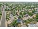 Aerial view of a blue home in a quiet neighborhood surrounded by mature trees and greenery at 1922 Danube Way, Aurora, CO 80011