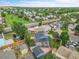Aerial view of a blue home featuring a deck and solar panels in a lush residential neighborhood at 1922 Danube Way, Aurora, CO 80011