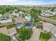 Aerial view of a blue home with solar panels and mature trees in a residential neighborhood at 1922 Danube Way, Aurora, CO 80011