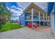 Rear exterior featuring covered deck, with a grassy lawn and storage underneath at 1922 Danube Way, Aurora, CO 80011