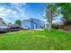 Large backyard with grass, mature trees and outbuilding at 1922 Danube Way, Aurora, CO 80011