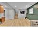 A finished basement with wood floors, built in wall unit and a sectional sofa at 1922 Danube Way, Aurora, CO 80011