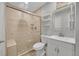 Updated bathroom featuring a tiled shower with glass door, new vanity, and modern fixtures at 1922 Danube Way, Aurora, CO 80011