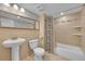 Neutral bathroom with pedestal sink, toilet, and tiled shower/tub combination at 1922 Danube Way, Aurora, CO 80011
