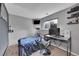 Cozy bedroom with a large window, desk, and neutral decor at 1922 Danube Way, Aurora, CO 80011
