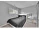 A bedroom featuring a bed, a vanity table, and sliding door closet at 1922 Danube Way, Aurora, CO 80011