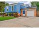 Charming two-story home boasts a blue exterior, white trim, stone accents, well maintained yard and large driveway at 1922 Danube Way, Aurora, CO 80011