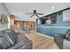 A living room and kitchen with a TV, hardwood floors, and ceiling fan at 1922 Danube Way, Aurora, CO 80011