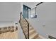 Modern staircase with wood treads and metal railing, leading to the upper level of the home with open landing at 1922 Danube Way, Aurora, CO 80011