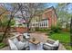 Expansive backyard featuring a stone patio, outdoor seating, manicured lawn, and a built-in fire pit for entertaining at 963 N Lafayette St, Denver, CO 80218