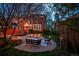 Backyard with patio, ambient lighting, mature trees, and a cozy seating area, perfect for evening relaxation and gatherings at 963 N Lafayette St, Denver, CO 80218