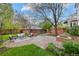 Backyard area with patio, seating, mature trees, landscaped garden, and outdoor fire pit perfect for outdoor enjoyment at 963 N Lafayette St, Denver, CO 80218